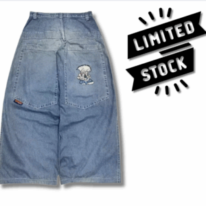 Blue baggy jeans with wide leg fit, mid-low waist, and white-haired cartoon character printed on the back pocket. Model styled with streetwear outfit.