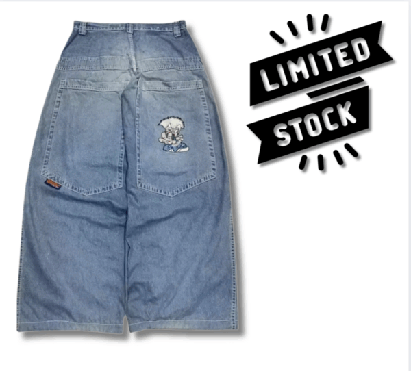 Blue baggy jeans with wide leg fit, mid-low waist, and white-haired cartoon character printed on the back pocket. Model styled with streetwear outfit.